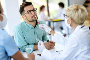 Young,Man,Getting,Pcr,Test,For,Coronavirus,During,Appointment,At