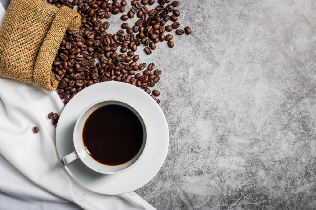 Background,Coffee,Cup,And,Beans,On,Old,Kitchen,Table.,Top