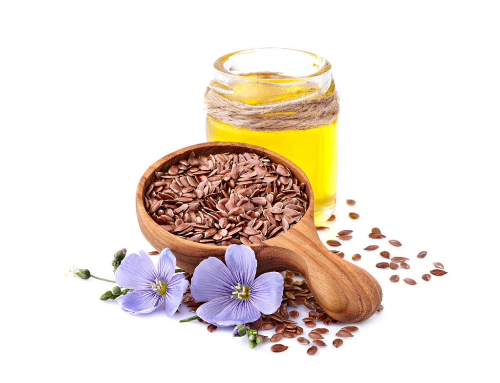 Flax,Seeds,In,Wooden,Spoon,With,Oil,On,White,Background.