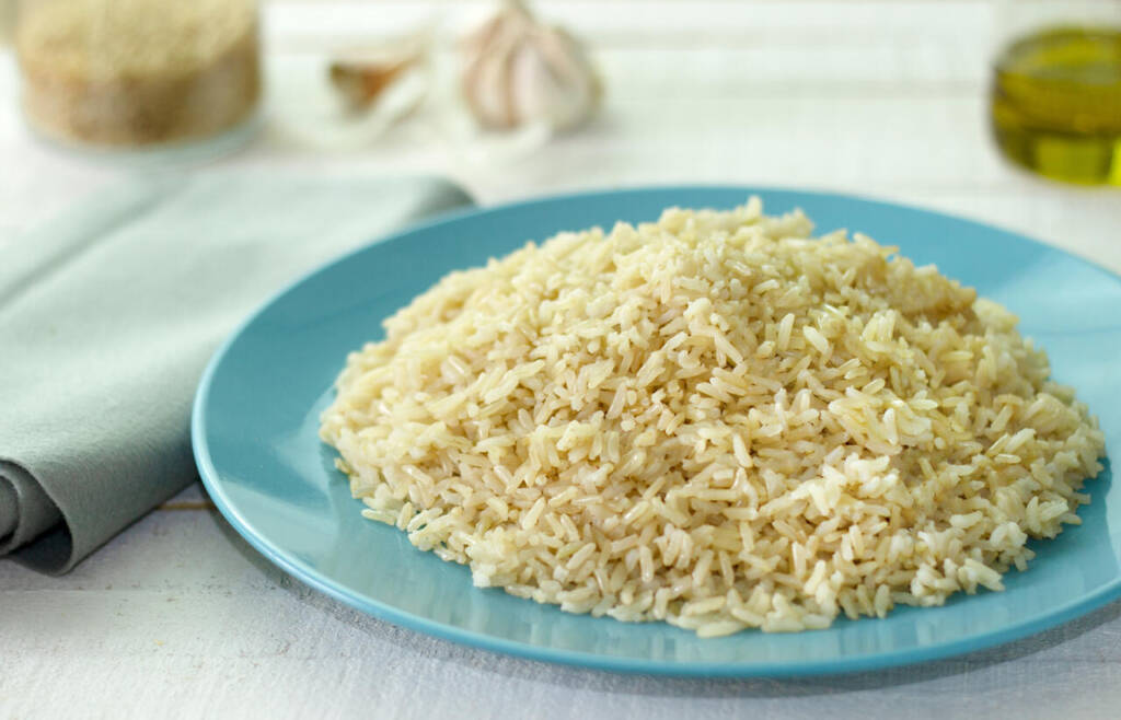 Organic,Brown,Rice,Grain,Cooked,In,Blue,Dish,On,Rustic