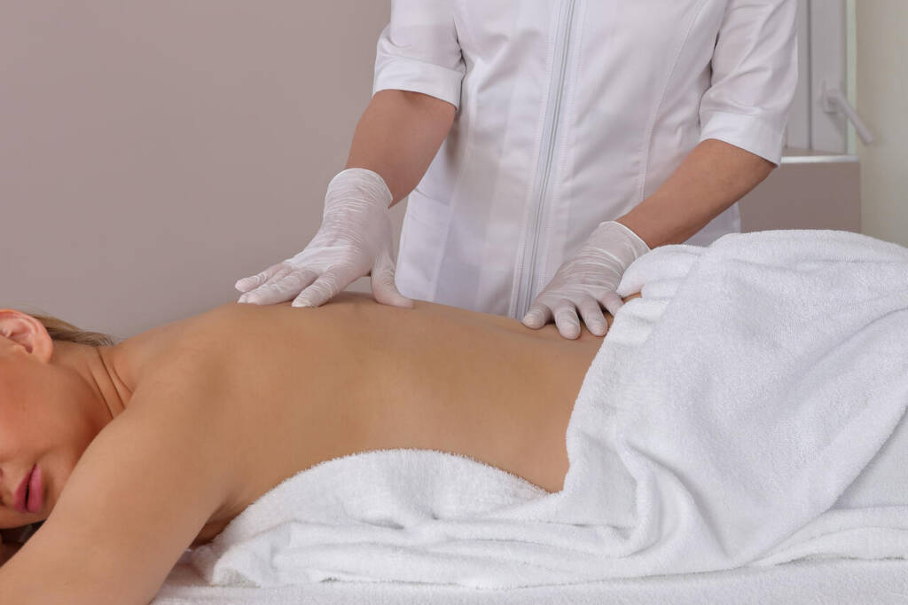 Woman,Having,Chiropractic,Back,Adjustment.,Osteopathy,,Alternative,Medicine,,Pain,Relief