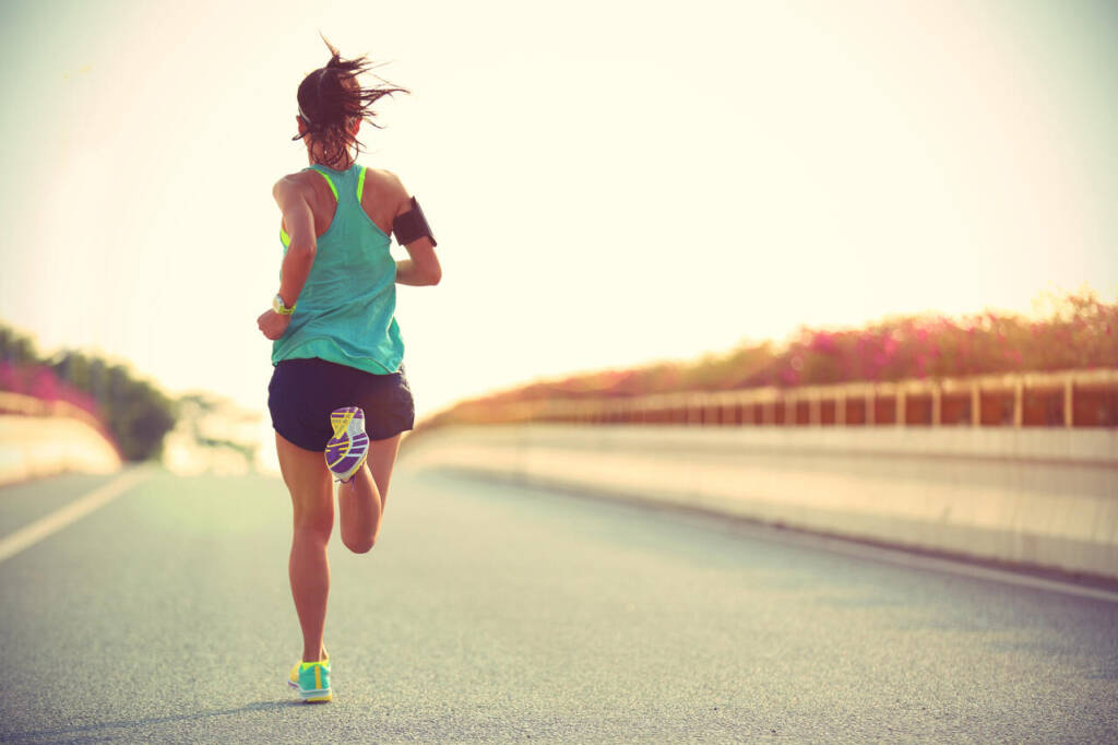 Young,Woman,Runner,Running,On,City,Bridge,Road